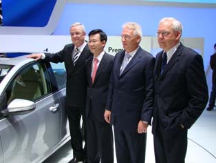 Executives of Volkswagen take a commemorative photo after the announcement of a new vehicle