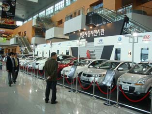 Exhibitor models line the event hall entrance