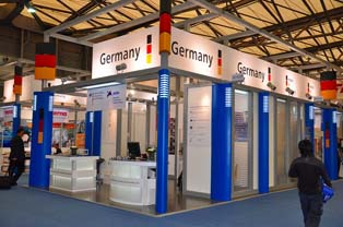 Display booth highlighting German products. Focus on high-performance replacement parts