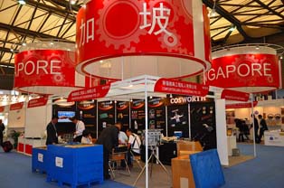 Display booth highlighting products from Singapore. Focus on lubricants and electronic components