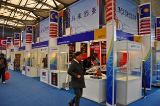 Display booth highlighting products from Malaysia. Focus on small plastic parts and electronic components