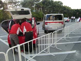 Staff preparing the Mitsubishi i-MiEV for test drive.